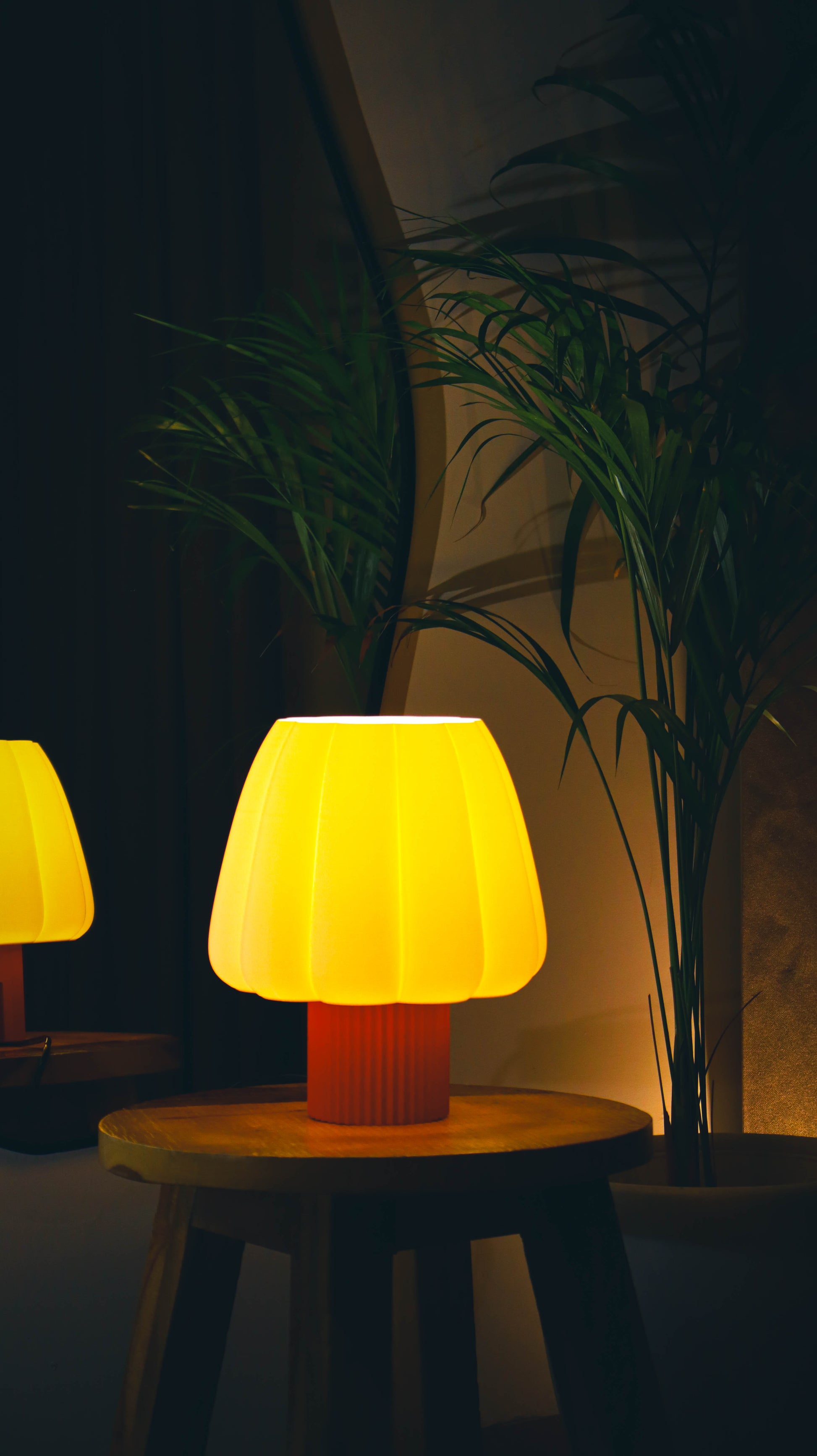 Cozy bedroom lamp with yellow shade and red base, warm ambient glow