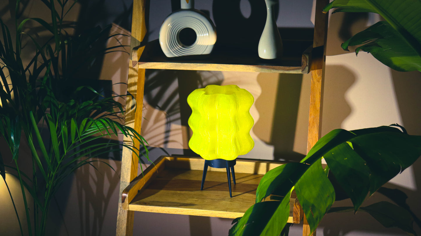 Yellow lamp on a wooden shelf with plants and an aesthetic background