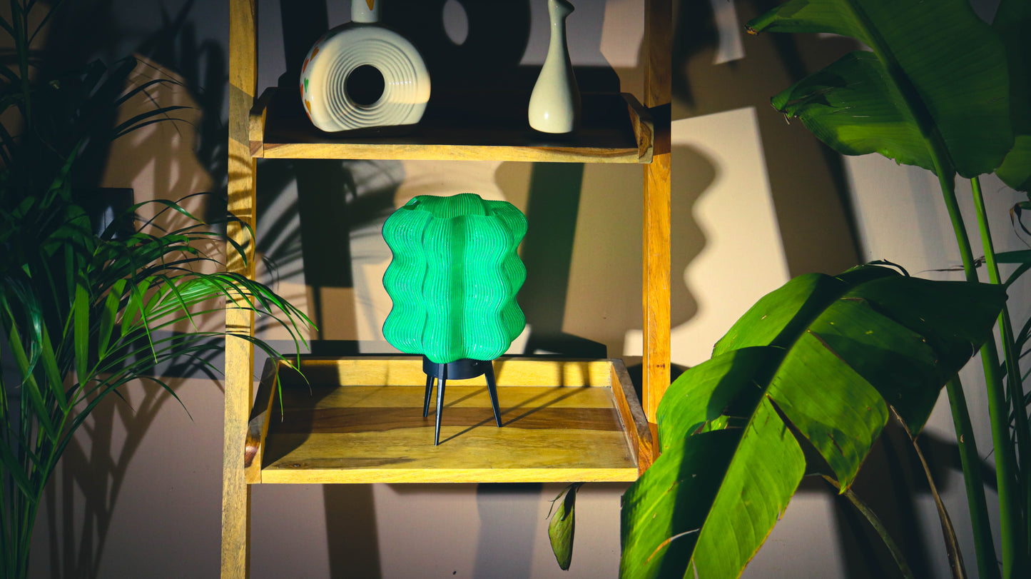 Modern green LED lamp with wave texture and tripod legs, home decor styling