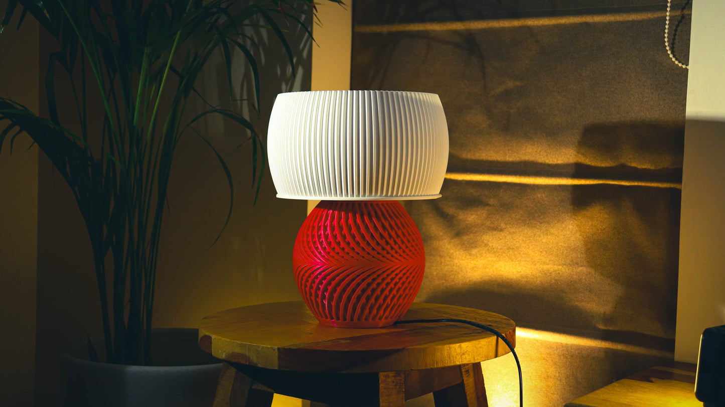 Modern red spiral base table lamp with white fluted shade, warm ambient lighting
