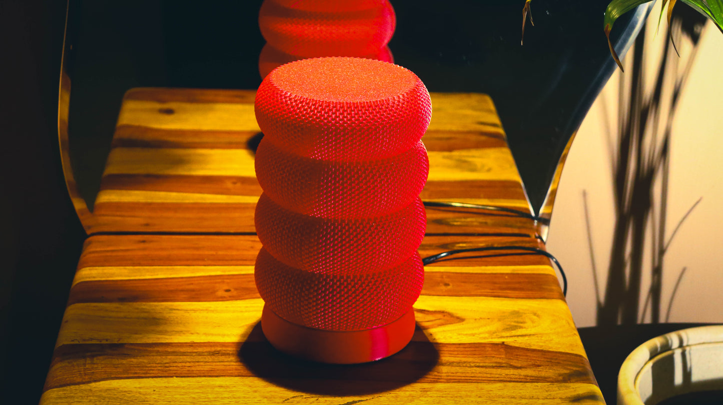 Modern red lamp with layered ring design and knit textured finish