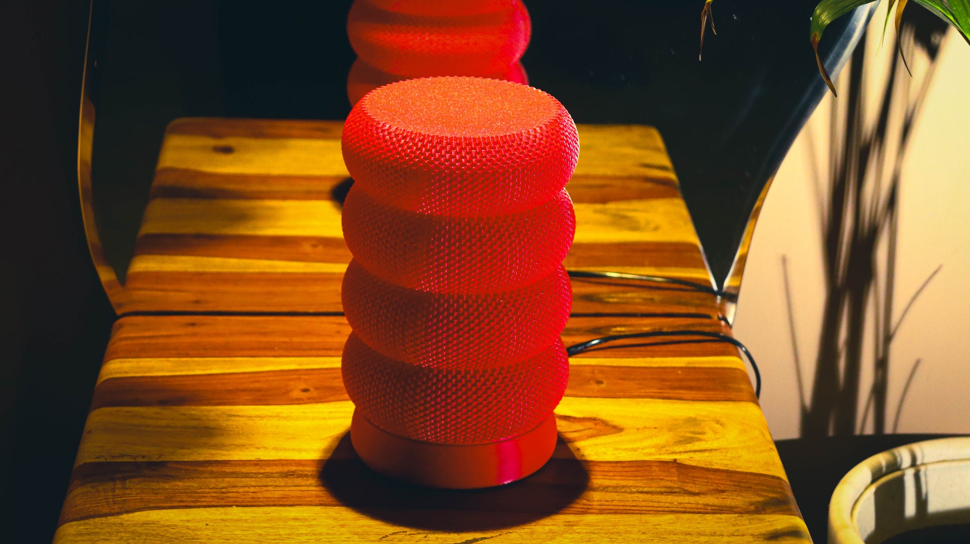 Modern red lamp with layered ring design and knit textured finish