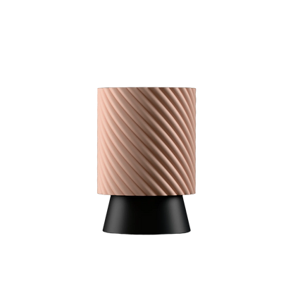 Table lamp with a peach textured shade and black base on a white background