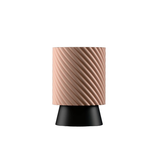 Table lamp with a peach textured shade and black base on a white background