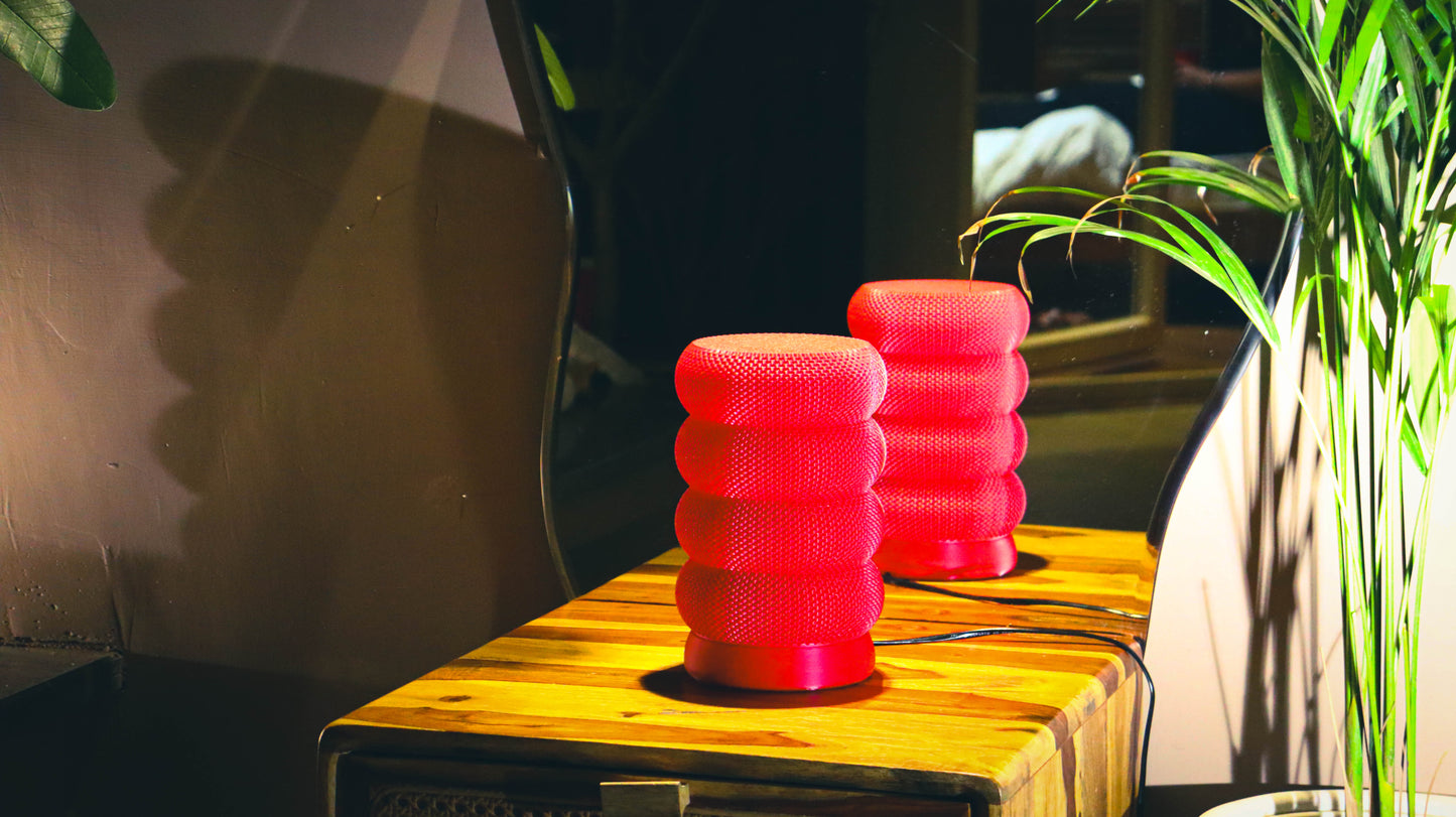 Kairo red stacked ring lamps, pair on wooden table with plant styling